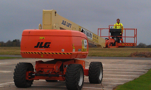 Diesel powered boom lift in use on a site